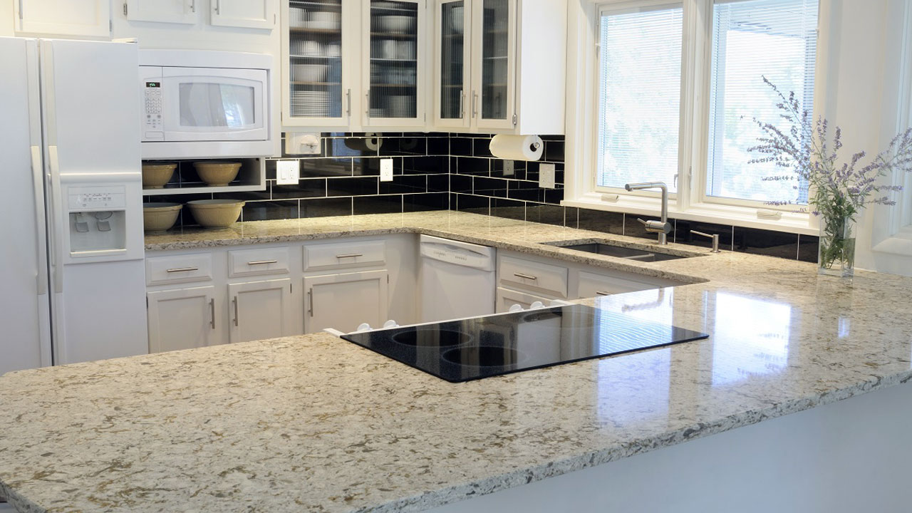 white granite countertops adorn this modern kitchen and highlight the black backsplash and white trimmings. Floor and Décor Backsplash tile inspiration