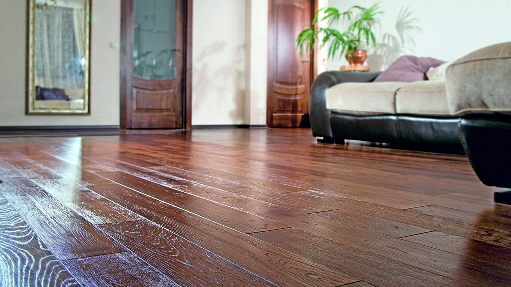 Glossy hardwood floors create a homey space by incorporating the hardwood trim and fixtures.