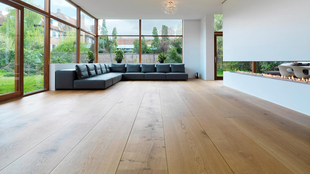 wide plank hardwood floors compliment wood trimming and glass walls in this simplistically styled home.